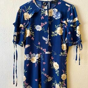 Beautiful little blue dress, flared with flowers and very new.